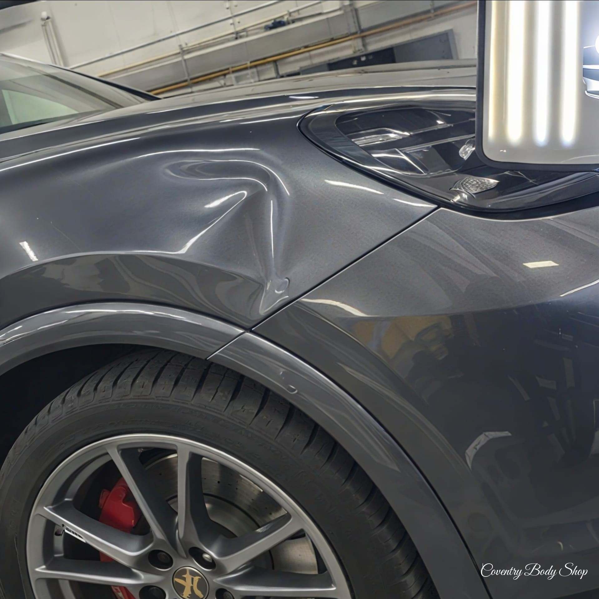 Porsche Cayenne's panel o/s front panel minor dent (before)